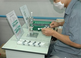 An operator assembling moulded parts on a fixture