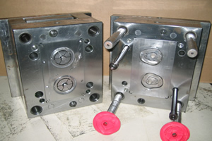 Two halves of a precision injection mould